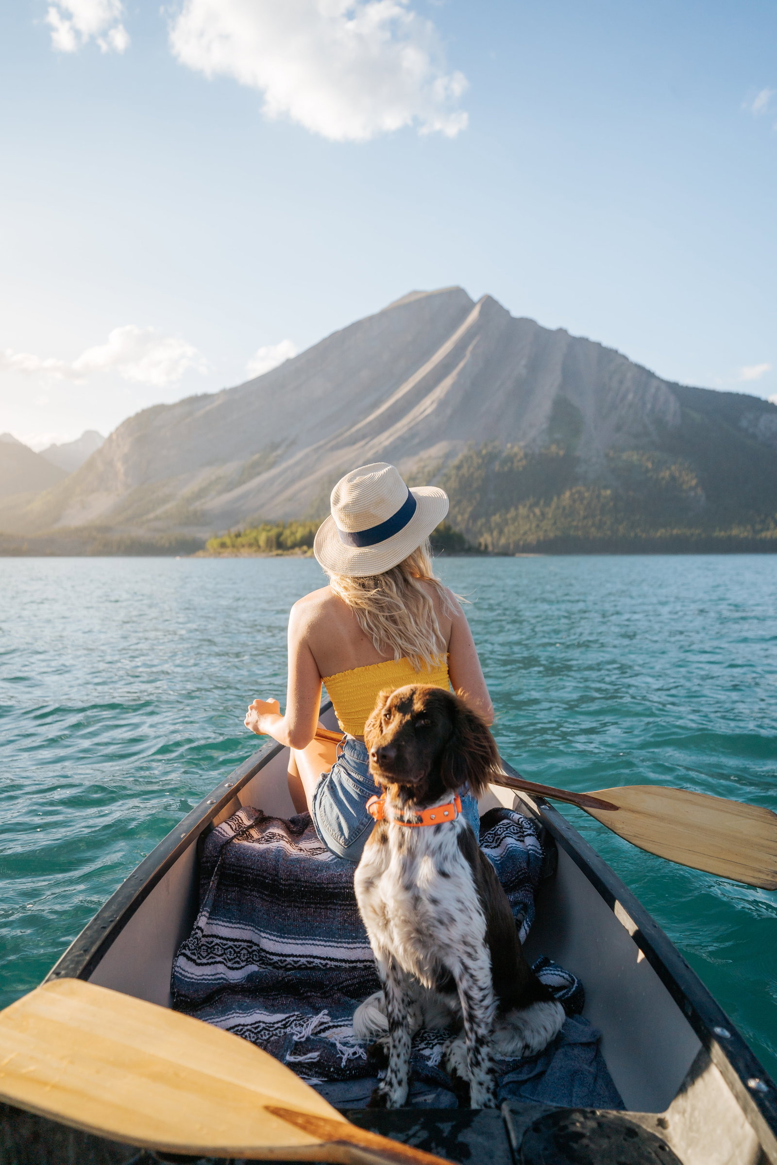 A girl canoeing with a dog in Banff National Park