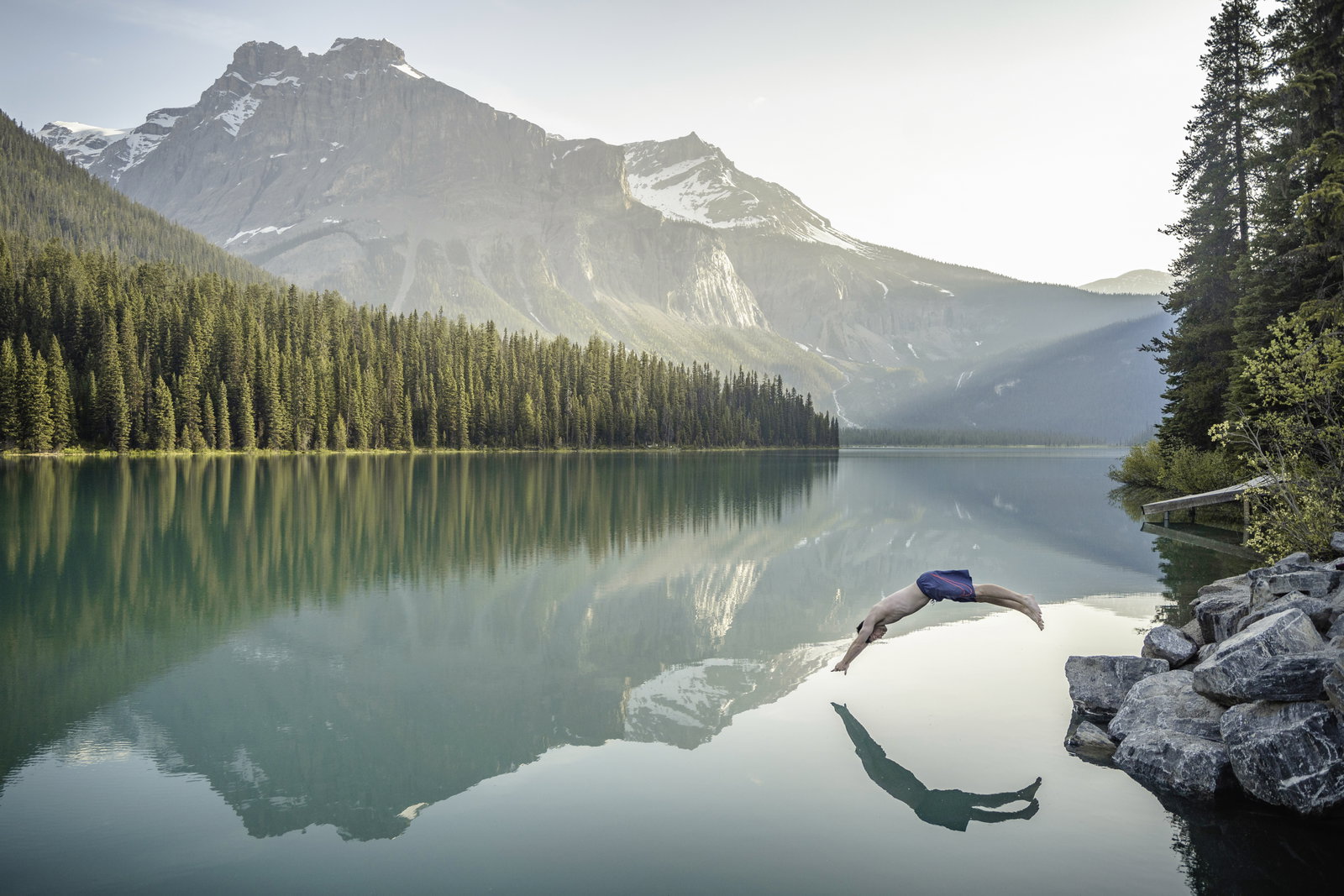 Man jumping into Emerald Lake in Banff National Park
