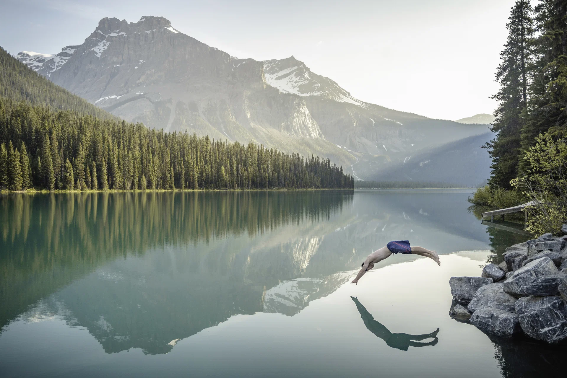 Man jumping into Emerald Lake in Banff National Park