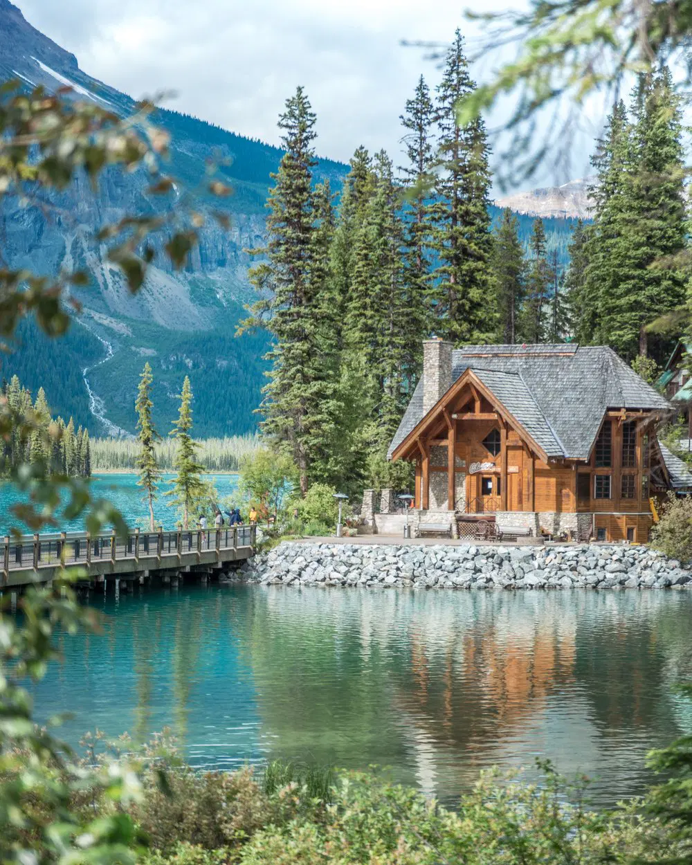 Crystal-clear emerald lake with mountains in the background