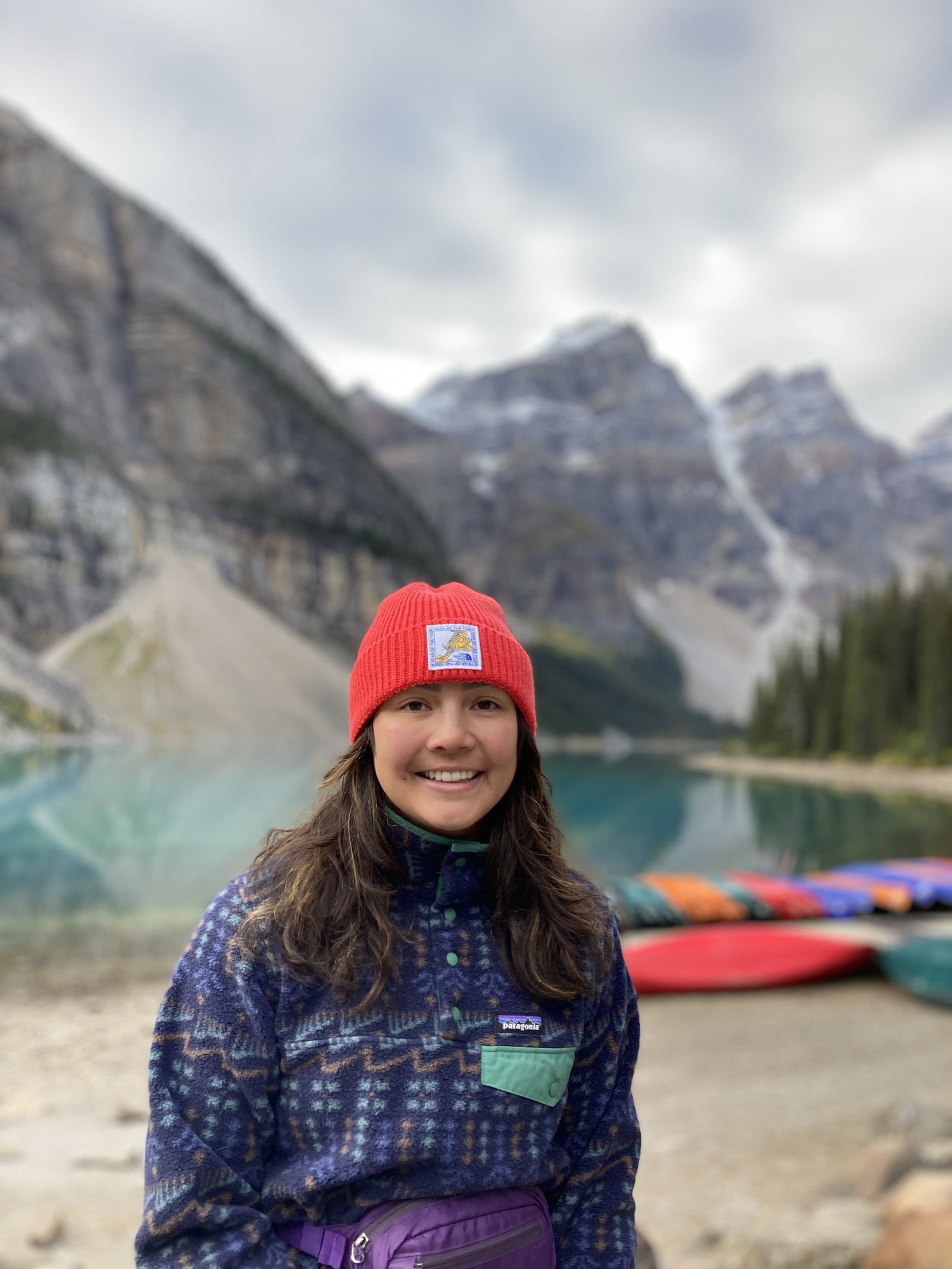Mount Bowlen Base - A girl standing on the shore of Moraine Lake in Banff National Park.