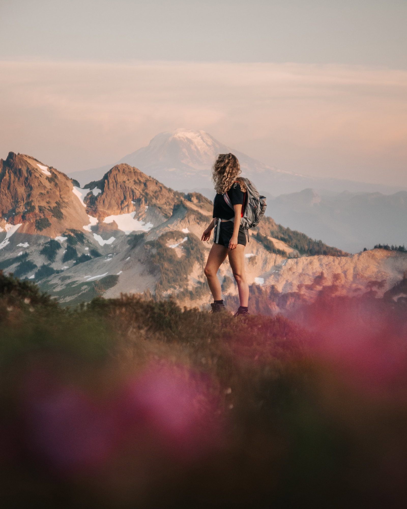 Wenchkemna Pass - A girl hiking through flowers in Banff National Park.