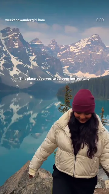 Woman in a red toque overlooking a turquoise alpine lake from a mountain trail