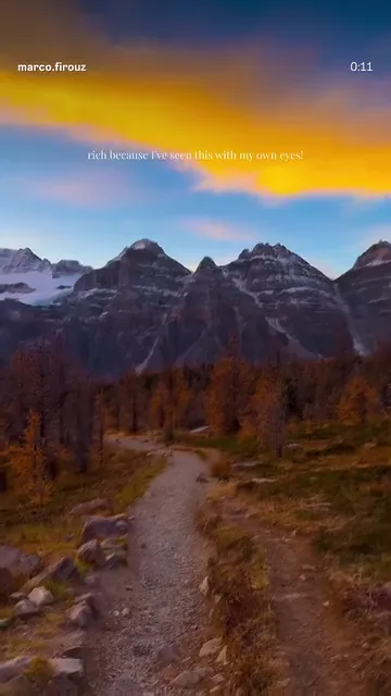 Orange dawn sky above the dark outline of the Canadian Rockies