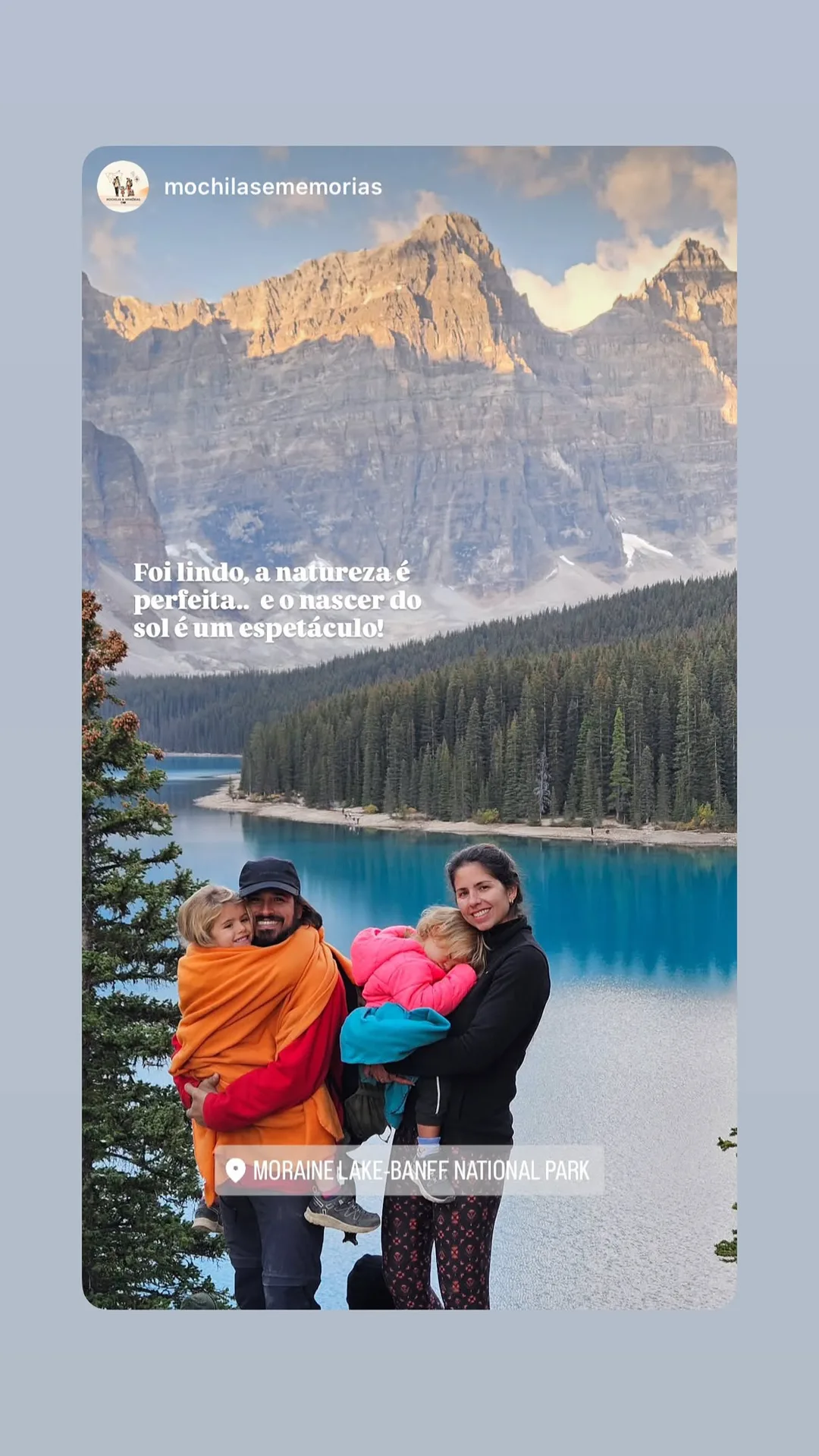 Couple holding a baby in front of Moraine Lake and the Valley of the Ten Peaks