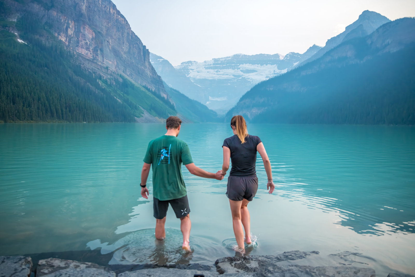 A couple going for a swim in Lake Louise
