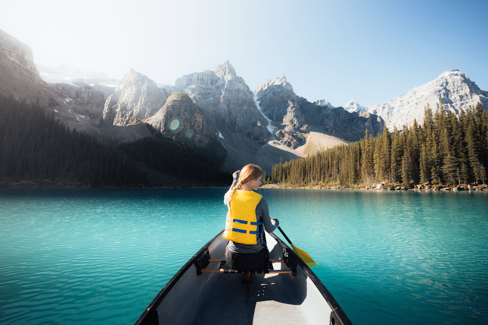 Woman paddling on turquoise waters of Moraine Lake