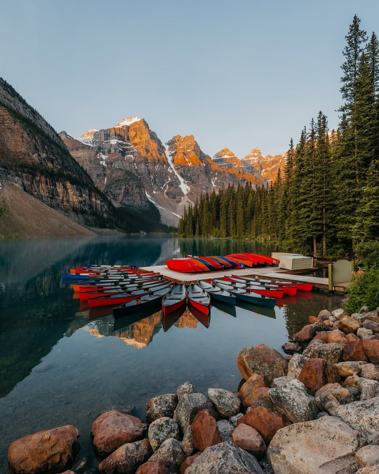 Moraine Lake canoes at sunrise in Banff National Park.
