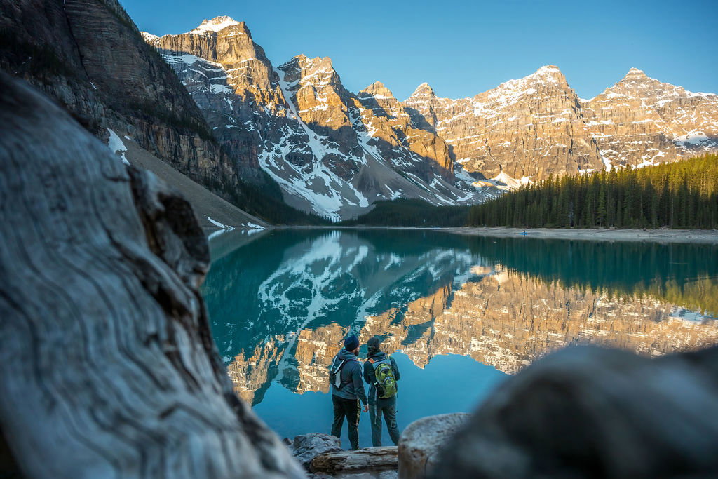 A couple enjoying the view of Moraine Lake in Banff National Park at water.