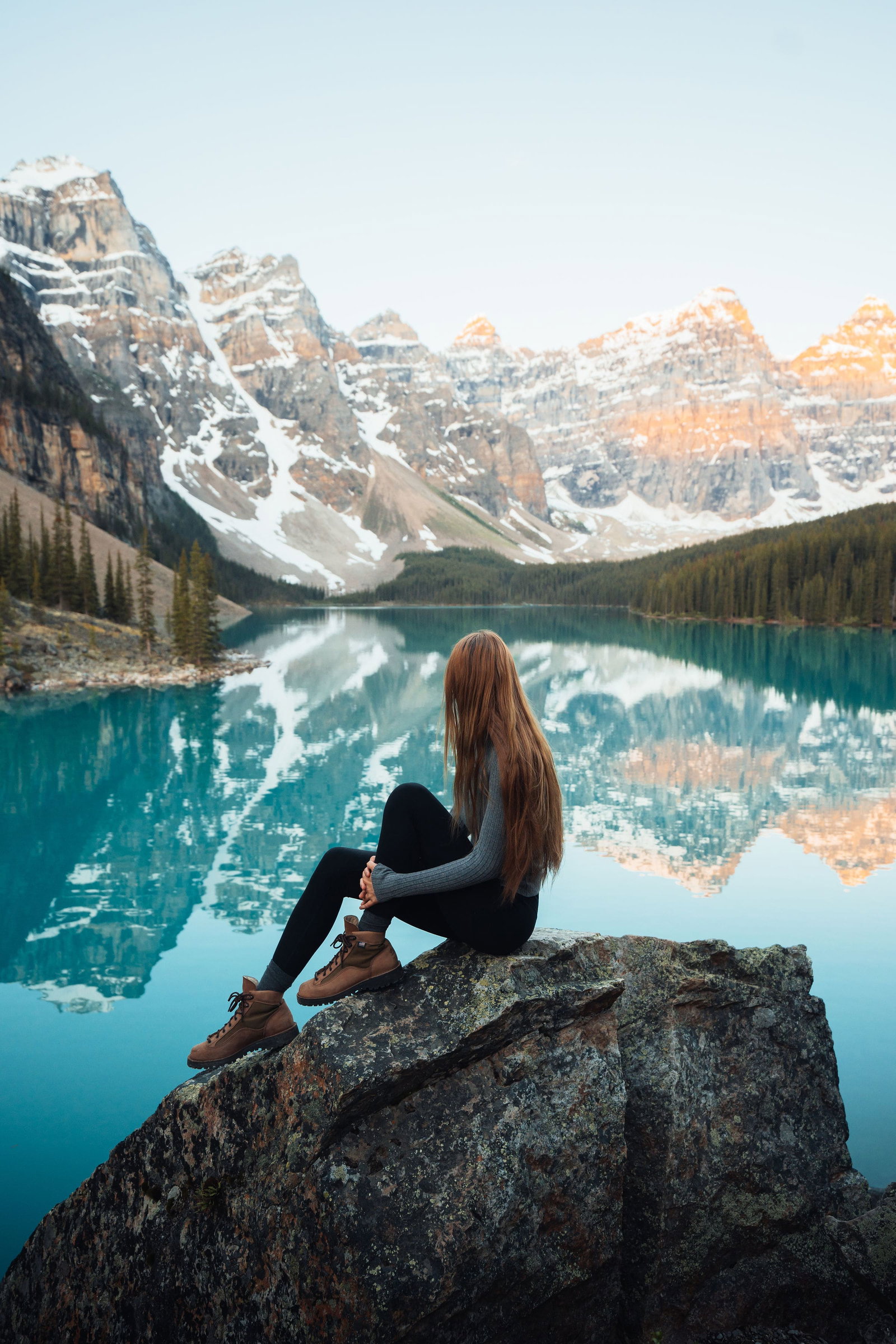 Lakeshore Trail - A girl sitting on a rock at Moraine Lake in Banff National Park.