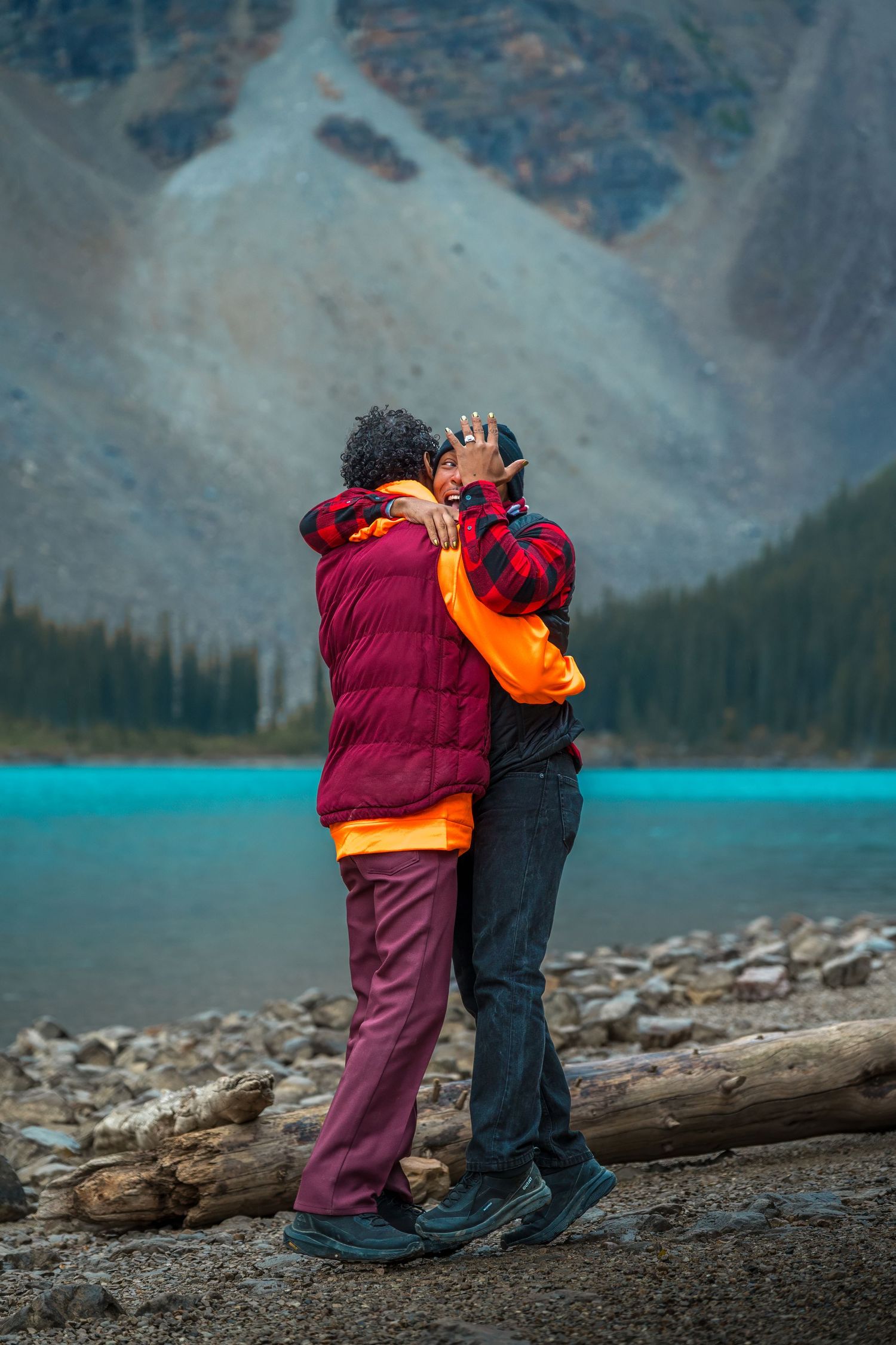 A couple proposing at Moraine Lake in Banff National Park crying.