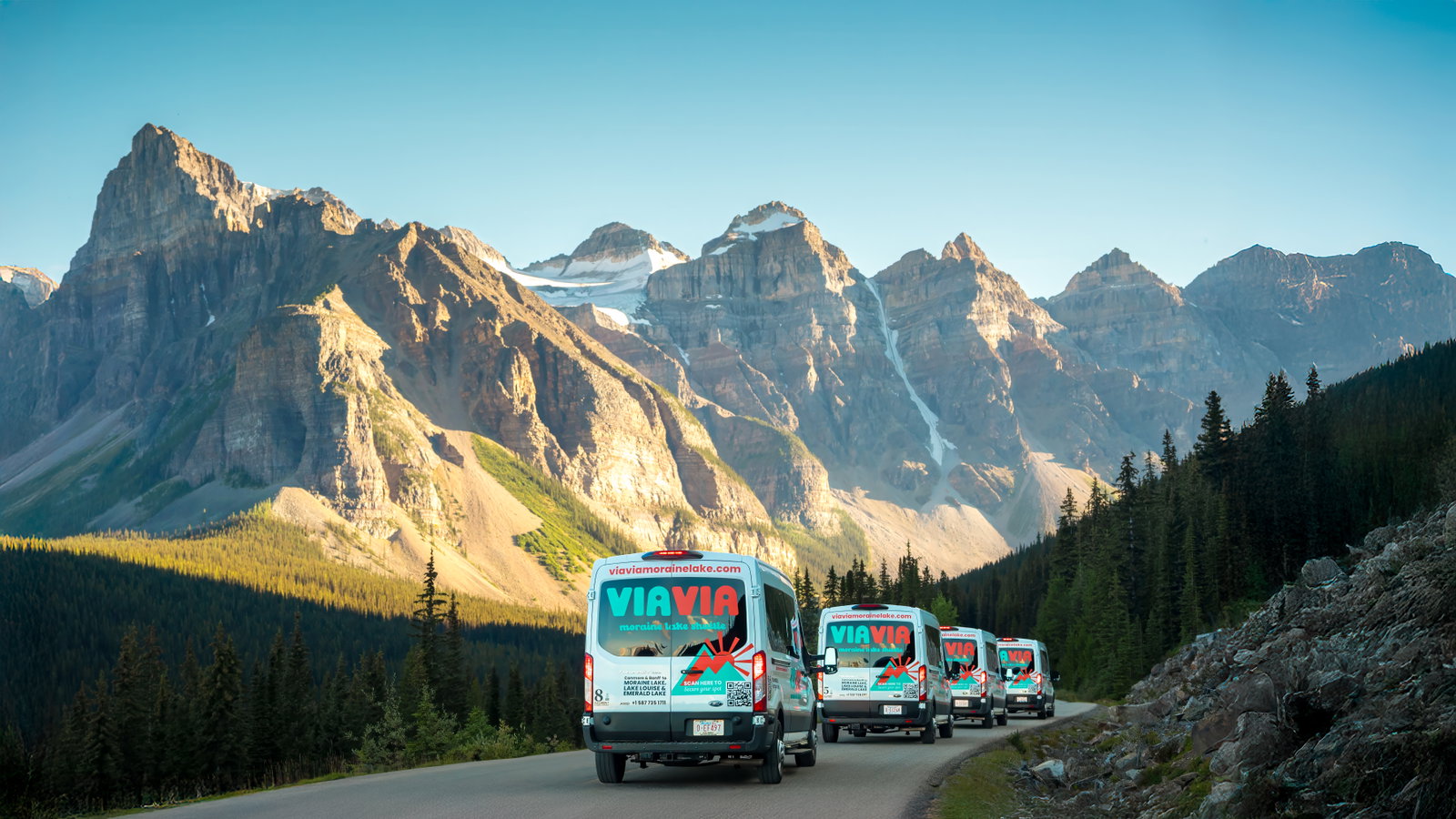 Via Via shuttles driving up Moraine Lake Road in Banff National Park