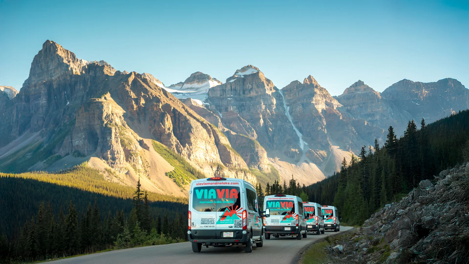 Via Via shuttles driving up Moraine Lake Road in Banff National Park