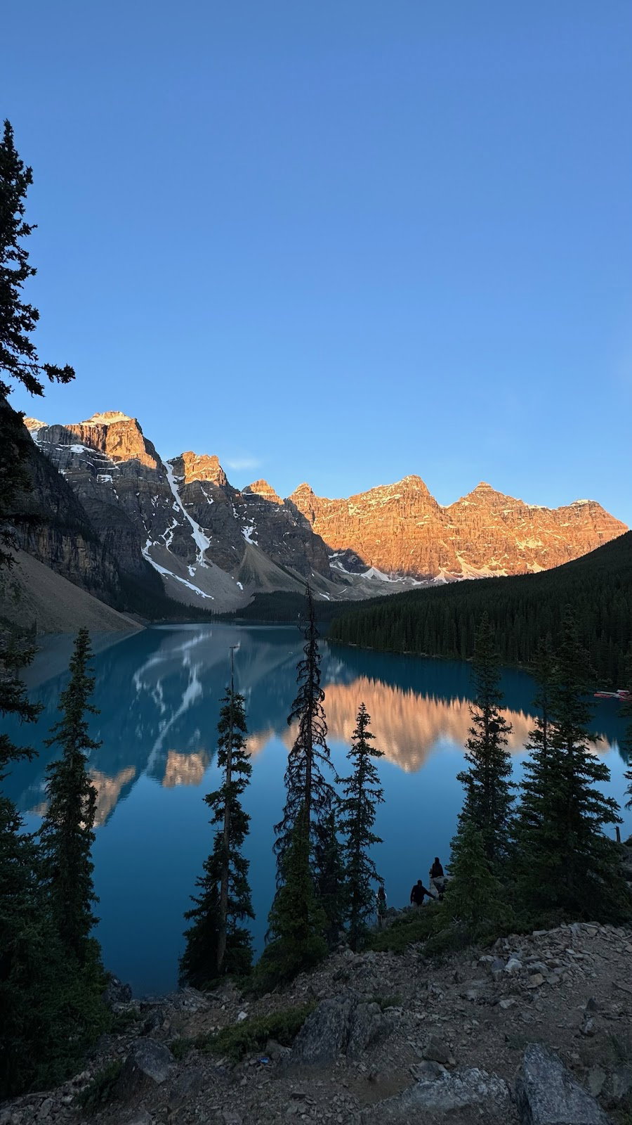 Sunrise illuminating the Valley of the Ten Peaks and reflecting on Moraine Lake